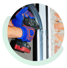 Technician repairing a broken garage door spring